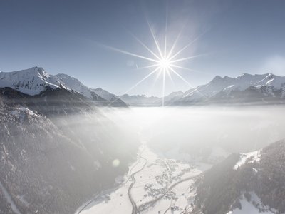 Your holiday apartment in Neustift ✓ Snowy mountain landscape with valley fog and bright sun