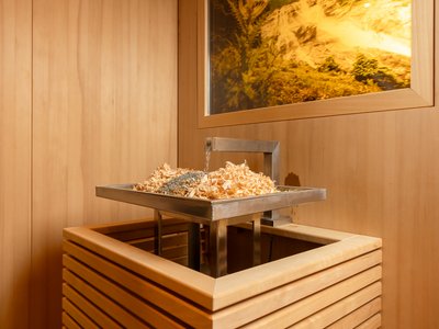Mach im Stubaital Wellness! ☯ Innenecke eines Dampfbads mit Holzspänen und Wasserquelle