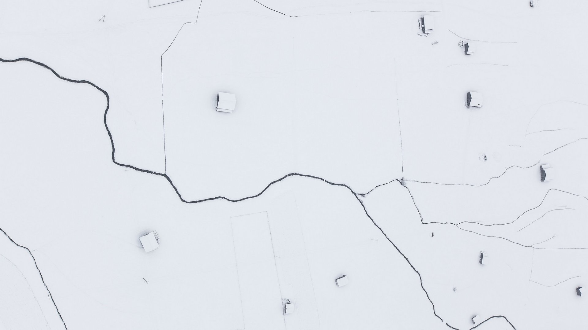 Your holiday apartment in Neustift ✓ Aerial view of snow-covered land with scattered houses and dark paths